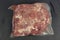 frosted mutton meat in plastic pack closeup photo on kitchen board