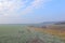 Frosted wheat fields and woodlands above a valley in winter