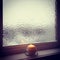 Frosted winter window and burning candle