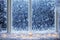 Frostwork. Close up of snowflakes and frost on the window glass. Winter background.