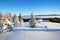 On a frosty beautiful day among high mountains and peaks are magical trees covered with white fluffy snow.