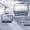 Frosty chair lifts against sunlit snow in winter