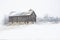 Frosty and foggy winter day with an old barn