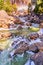 Frosty rocks with cascading blue waters and rainbow in background