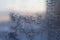 Frosty snowflake pattern on the window glass