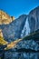 Frosty upper Yosemite Falls with sun creeping over cliffs
