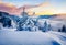 Frosty winter sunrise in Carpathian mountains with snow covered fir trees. Impressive morning scene of mountains hills covered by