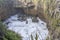 Froth and cliffs at narrow inlet of Tasman sea shore, Punakaiki, West Coast, New Zealand