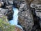 Frothing water gushing through a canyon at banff national park