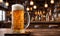 Frothy beer being poured into a chilled glass