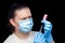 Frowning doctor in a medical mask and sterile blue gloves.