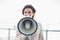 Frowning stylish brown haired businesswoman using a megaphone