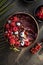 Frozen acai smoothie in coconut shell with raspberries, banana, blueberries,  fruit and granola on concrete background. Breakfast