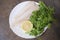 Frozen Alaska Pollock fillet with lemon and parsley on white plate.