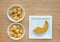 Frozen baby food homemade, Yellow heart and star from pumpkin Cubes in ceramic bowl on wooden board