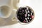 Frozen berries, black currants, in a porcelain dish. view from above. macro