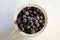 Frozen berries, black currants, in a porcelain dish. view from above. macro