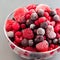 Frozen berries in a glass bowl, raspberry, strawberry, cranberry and black currant, square format