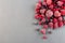 Frozen berries on  gray background, raspberry, strawberry, cranberry and black currant, horizontal, copy space, top view