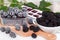 Frozen blackberries in a saucer on a wooden board