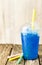 Frozen Blue Slushie in Plastic Cup with Straw