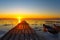 frozen boat in winter on the lake at sunrise