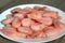 Frozen boiled shrimps lie on a white plate.