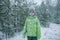 Frozen boy in warm clothes walks in forest with the first long-awaited snow, winter wonderland