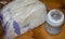 Frozen breastmilk in storage bags and baby bottle with fresh expresed breast milk on wooden table