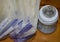 Frozen breastmilk in storage bags and baby bottle with fresh expresed breast milk on wooden table