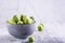 Frozen Brussels sprouts in a bowl on a gray background. Vegetarian food