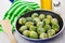 Frozen brussels sprouts in frying pan, vegetable oil, salt, spat