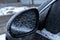 Frozen car rearview mirror in winter, close-up