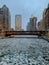 A frozen Chicago River with cracked ice chunks during frigid January evening