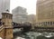 Frozen chunks of ice on Chicago River during heavy snowfall on December afternoon.