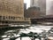 Frozen chunks of ice floating on Chicago River during snow storm.