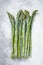 Frozen cold asparagus on a old kitchen table. White background. Top view