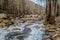 Frozen creek in winter with snow and ice