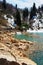 Frozen crystal blue lake and snowy woodland in winter Georgia. Shaori lake, Racha. Caucasus. Colorful vibrant outdoors