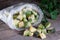 Frozen cubes of zucchini in a plastic bag on the wooden background