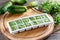 Frozen cucumber puree in ice cube trays ready for freezing on a cutting board on a table. Frozen Food Concept