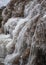 Frozen Dauda waterfall in winter. Close up water stream.