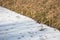 Frozen ditch covered with ice and snow