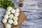 Frozen dough khinkali with spinach. Garnished with Red Chilli, Dill and Parsley. On a wooden background