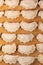 frozen dumplings lying in rows on wooden board. Top view