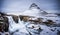 Frozen famous waterfall near mountain in Iceland