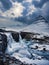 Frozen famous waterfall near mountain in Iceland