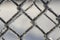 Frozen fence made of metal mesh covered with frost crystals, an