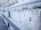 Frozen fence in winter. Huge icicles close up