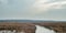 Frozen fens in wide heathland on overcast winter day.